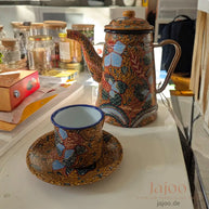 Batik enamel tea set styled in a modern living room