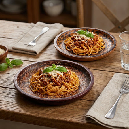 Cerita batik pattern plates set on a dining table with pasta