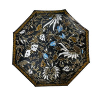 Payung Lukis hand-painted batik umbrella – Lung-Lungan vine and blossom motif on midnight-black canopy with gold border