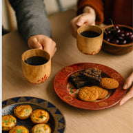 Hand-painted round plate styled on a table, crafted by Indonesian artisans