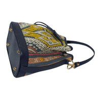 Detail of the handwoven songket weave and leather stitching on the mini bucket bag